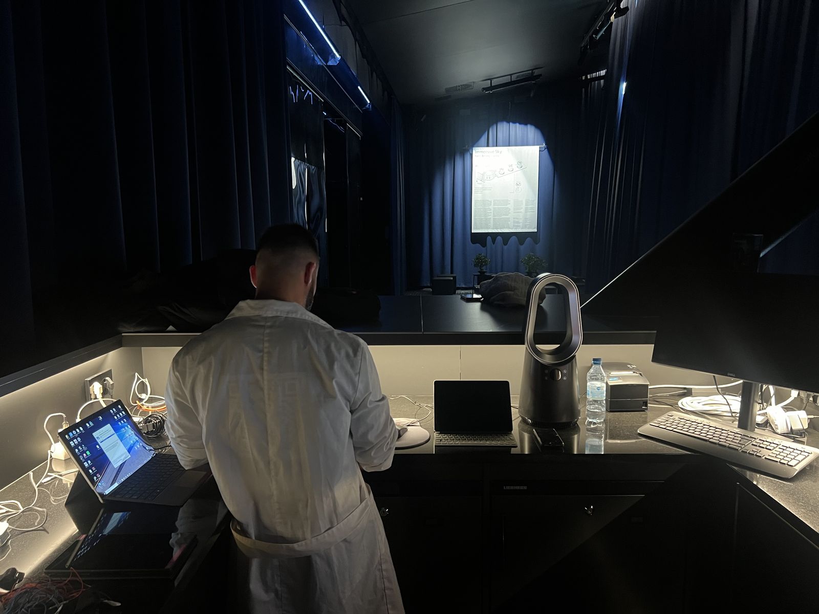 A researcher at a lab bench preparing EEG equipment for a pilot study