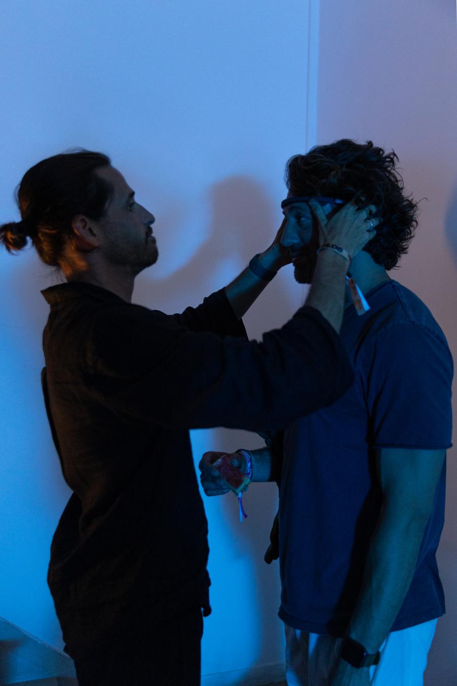 A practitioner fitting an EEG headset on a participant