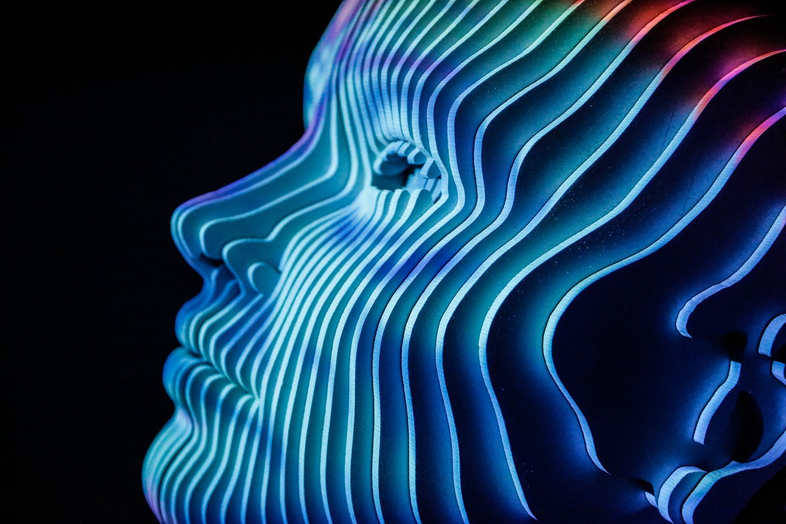 Layered blue and violet LED sculpture of a human profile