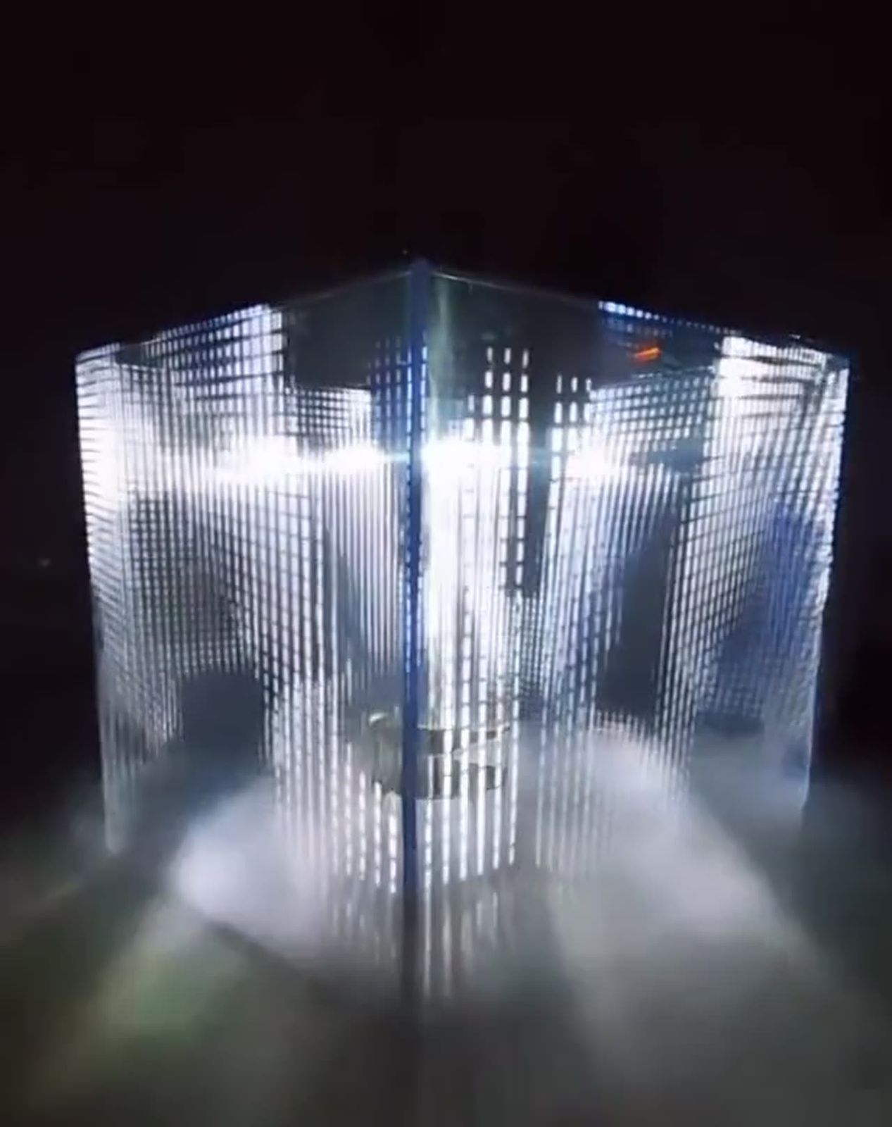 The Voxel Cube, a walk-in cube of light points glowing in a dark space